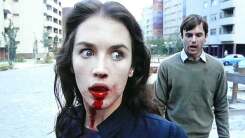 Woman with blood dripping from her mouth in a still from Possession