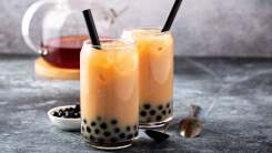 Two glasses of bubble tea on a table.