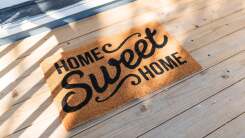 A welcome rug saying "Home Sweet Home."