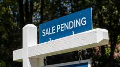 "sale pending" sign in front of a home