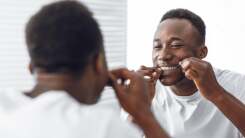 Man flossing (a habit that probably most of us want to build!)