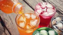 three glasses of colorful soda drinks