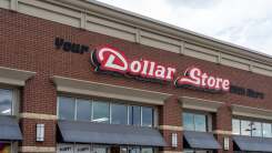 Front of a store with the sign "Your Dollar Store With More"