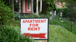 apartment for rent sign in front of grass