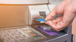 person inserting ATM card into machine