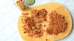 Clusters of granola on a cutting board.