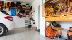 inside garage with SUV, tools, storage