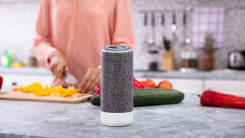 woman in kitchen with smart speaker in foreground