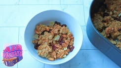 A bowl of granola next to an air fryer basket of granola. 
