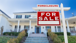 House with "Foreclosure" sign 