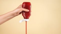 Woman pouring ketchup
