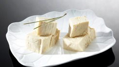 Flaky tofu on a white plate