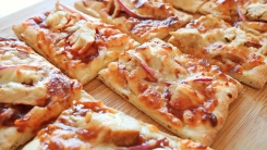 Close-up of pizza sliced in squares.