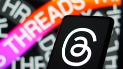 Threads logo on smartphone and desktop