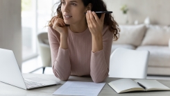 Woman listening to voicemail on smartphone