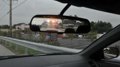 Police lights in a car's rearview mirror