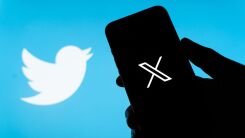 the X logo displayed on a smart phone next to the former twitter logo