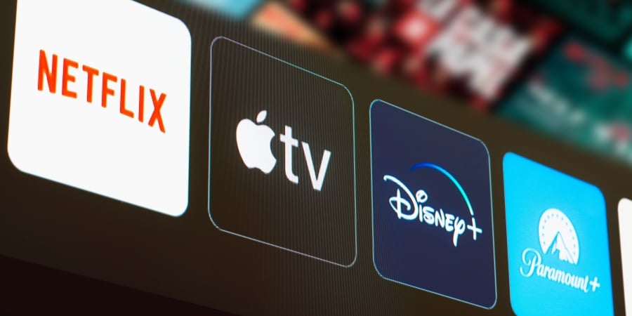 Netflix, Apple TV, Disney Plus and Paramount Plus logo is displayed on a TV screen.