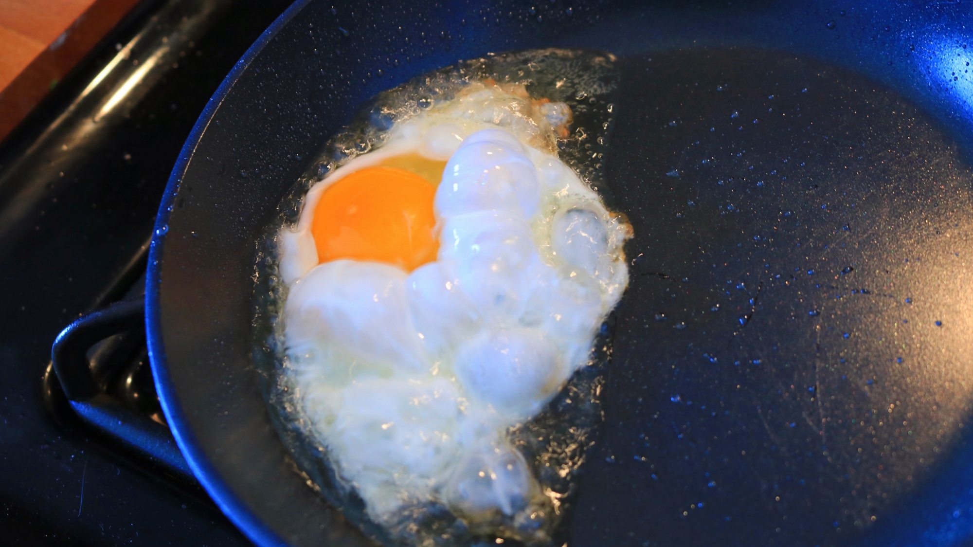 An egg frying in a pan.