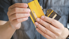 Man holding several credit cards