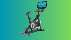 NordicTrack’s commercial S22i spin bike on a teal and green gradient background.