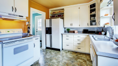 view of an outdated kitchen with white appliances