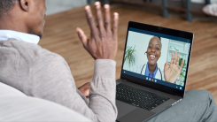 A person speaking with a doctor via video call on a laptop