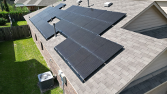 aerial view of solar panels on the roof of a house