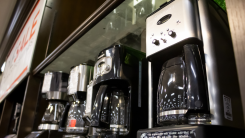 A lineup of Cuisinart coffee makers on a store shelf