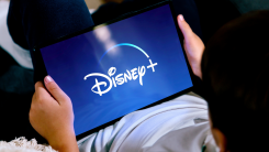 A boy watching Disney+ on a tablet