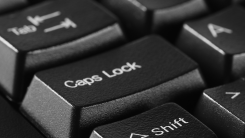 A Caps Lock key on a black keyboard