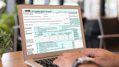A 1040 tax form open on a laptop screen