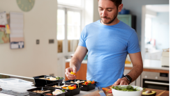 man portioning out healthy meals in kitchen