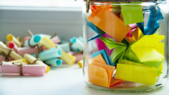 jar full of colorful folded up notes