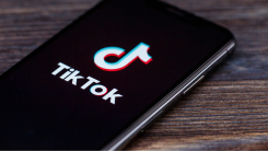 A photograph of a phone screen showing the TikTok logo