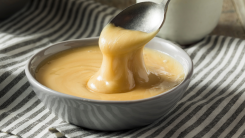 spoon stirring whipped honey in a bowl