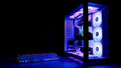 A gaming PC tower in a dark room, lit up from within by bright lights. 