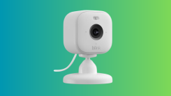 A product image of the Blink Mini 2 against a blue and green gradient background