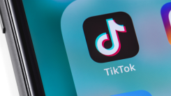 A close-up shot of a phone screen displaying the TikTok app logo