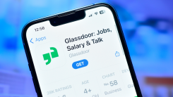 A photograph of a smartphone displaying the Glassdoor app's listing in the App Store