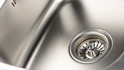 A closeup of a spotless stainless steel sink