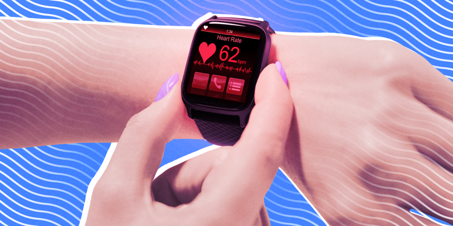 A closeup of a smartwatch on a wrist displaying heart rate data